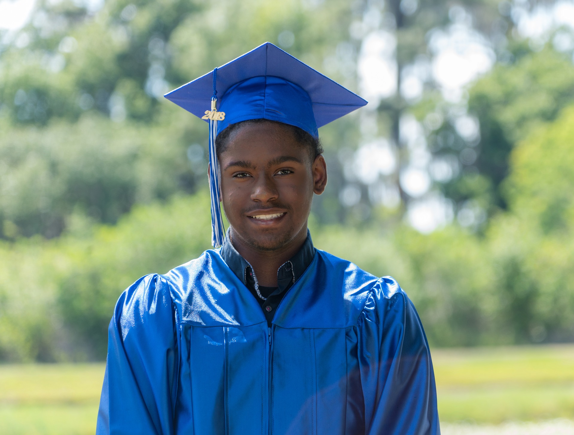young black man in graduation gown and mortarboard